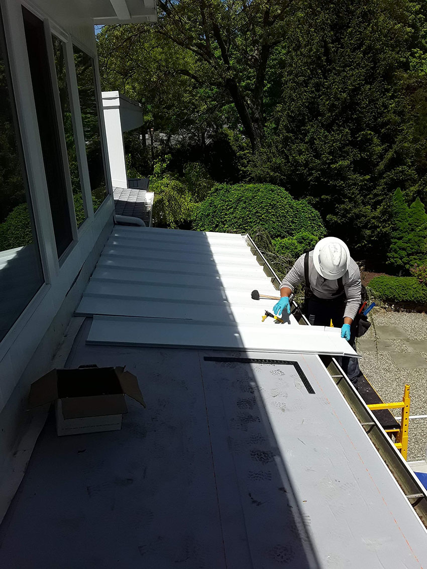 Premier Home Designs LLC roofing team working on residential shingle installation